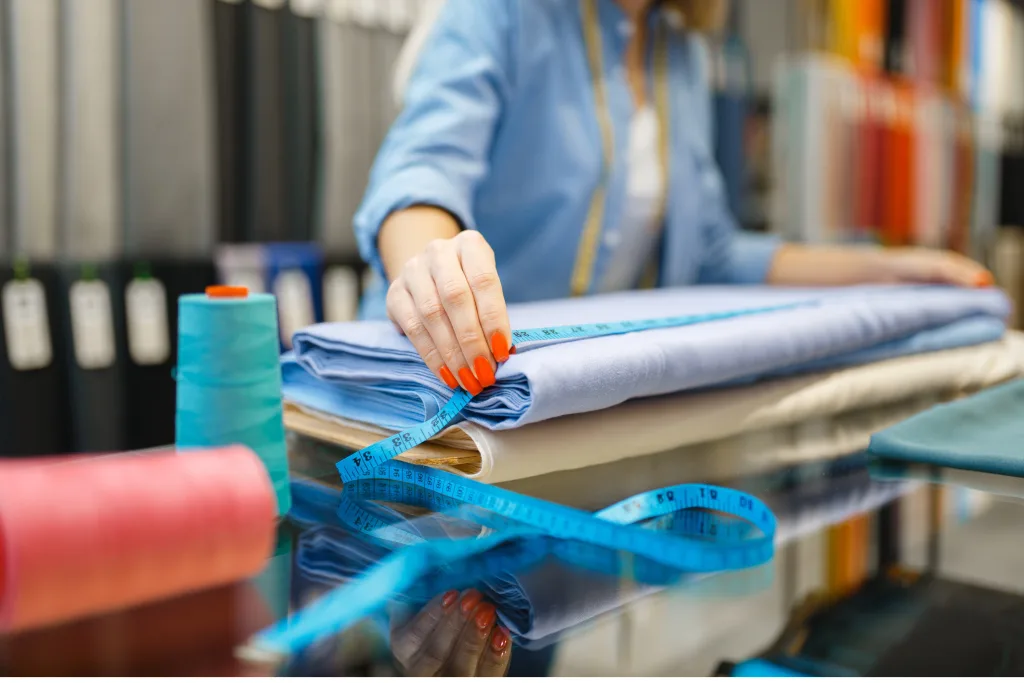 Women working with fabrics measuring