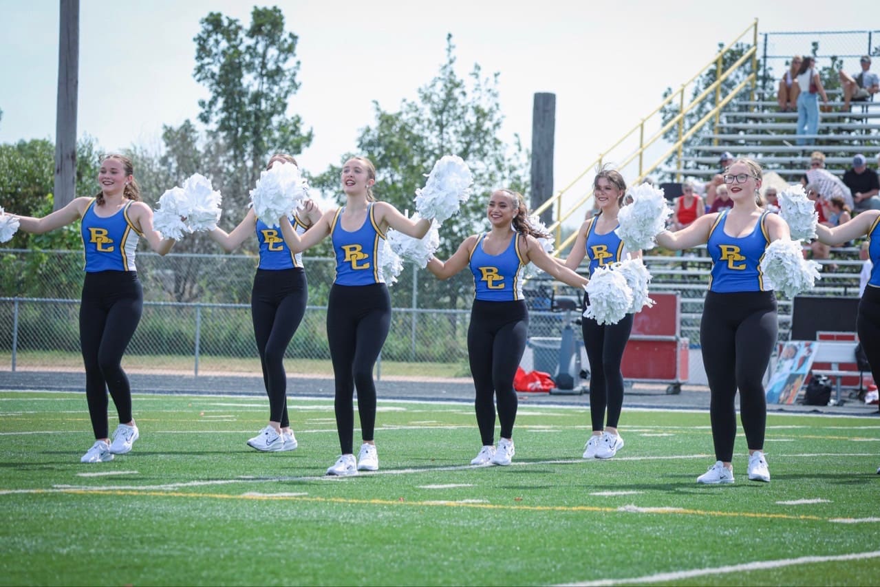 Briar Cliff University dance team performs in custom blue-and-gold pom uniforms.