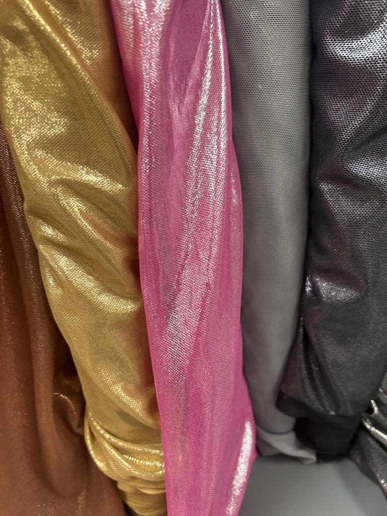 Gold, pink, and black specialty fabrics for dance costumes
