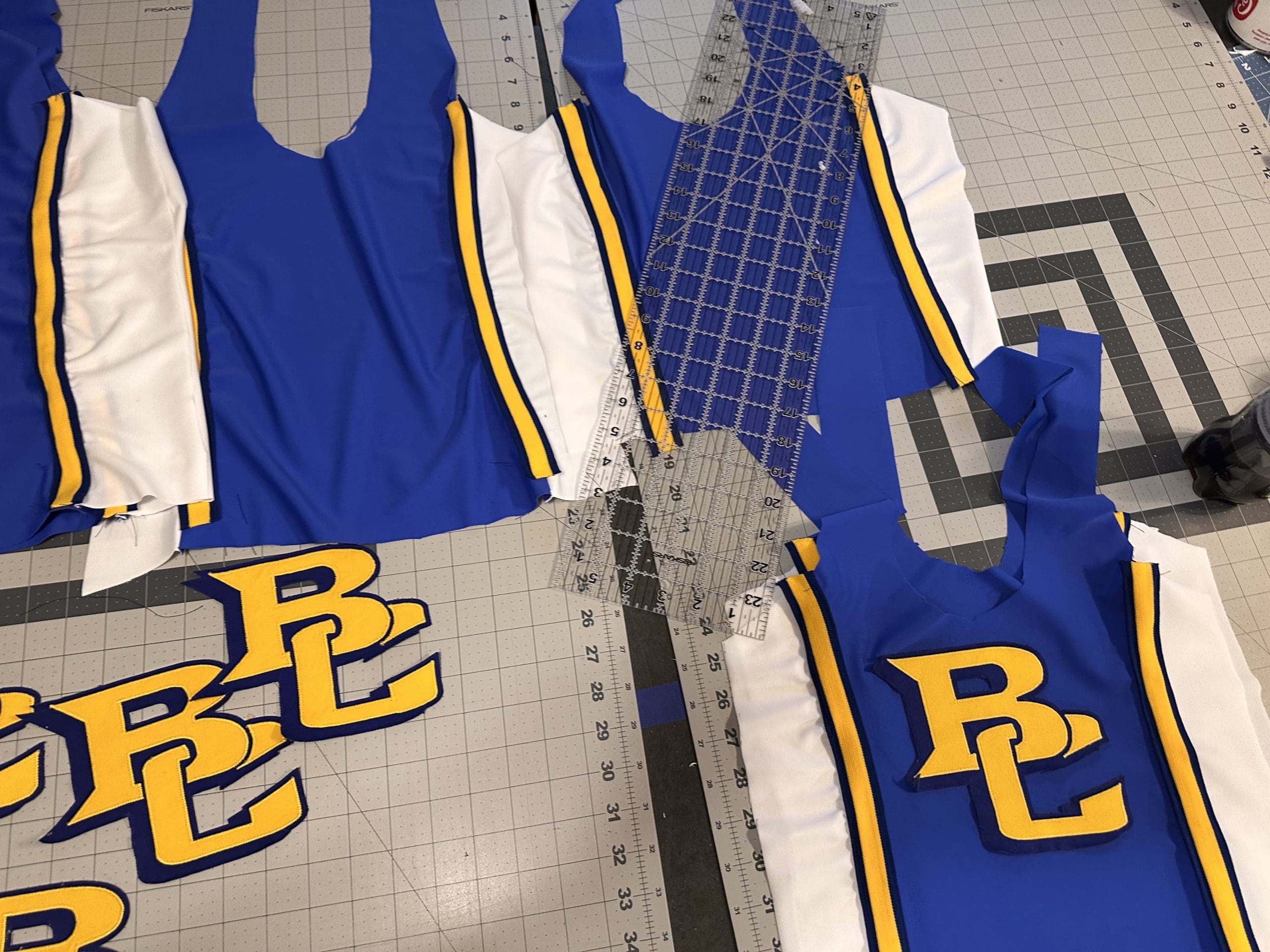 Custom pom costumes in school colors by Sewn 2 Dance custom Dancewear Pom Costume for Briar Cliff University Sioux City, Iowa in the middle of design 25-26