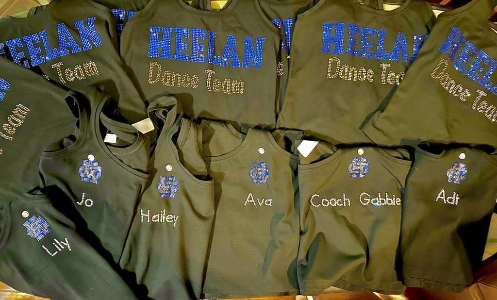 black tops rhinestoned with school name and logo and dancers name on back for game-day wear