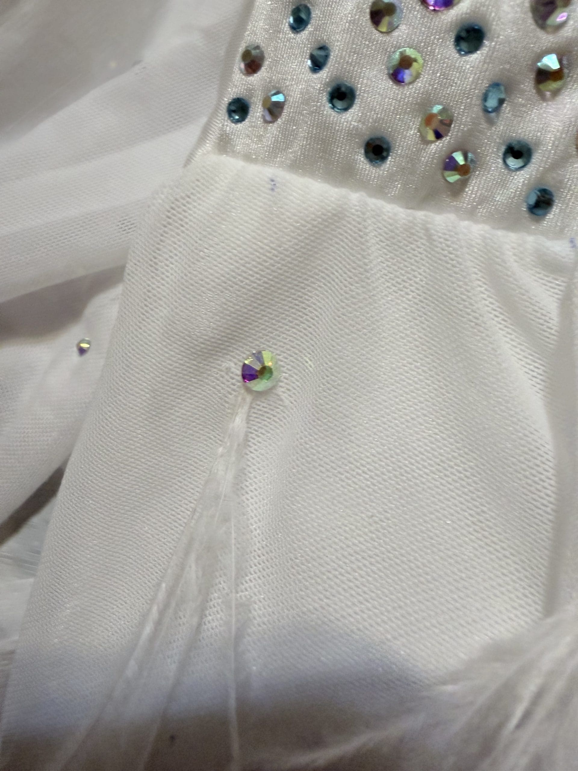 alterations white rhinestones and feather embellishment