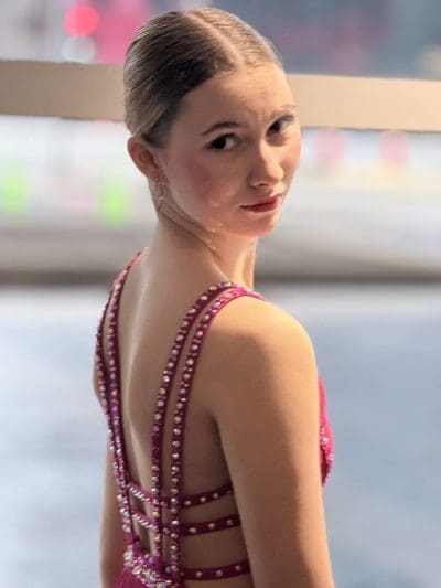 Dancer looking back over shoulder in pink rhinestoned costume