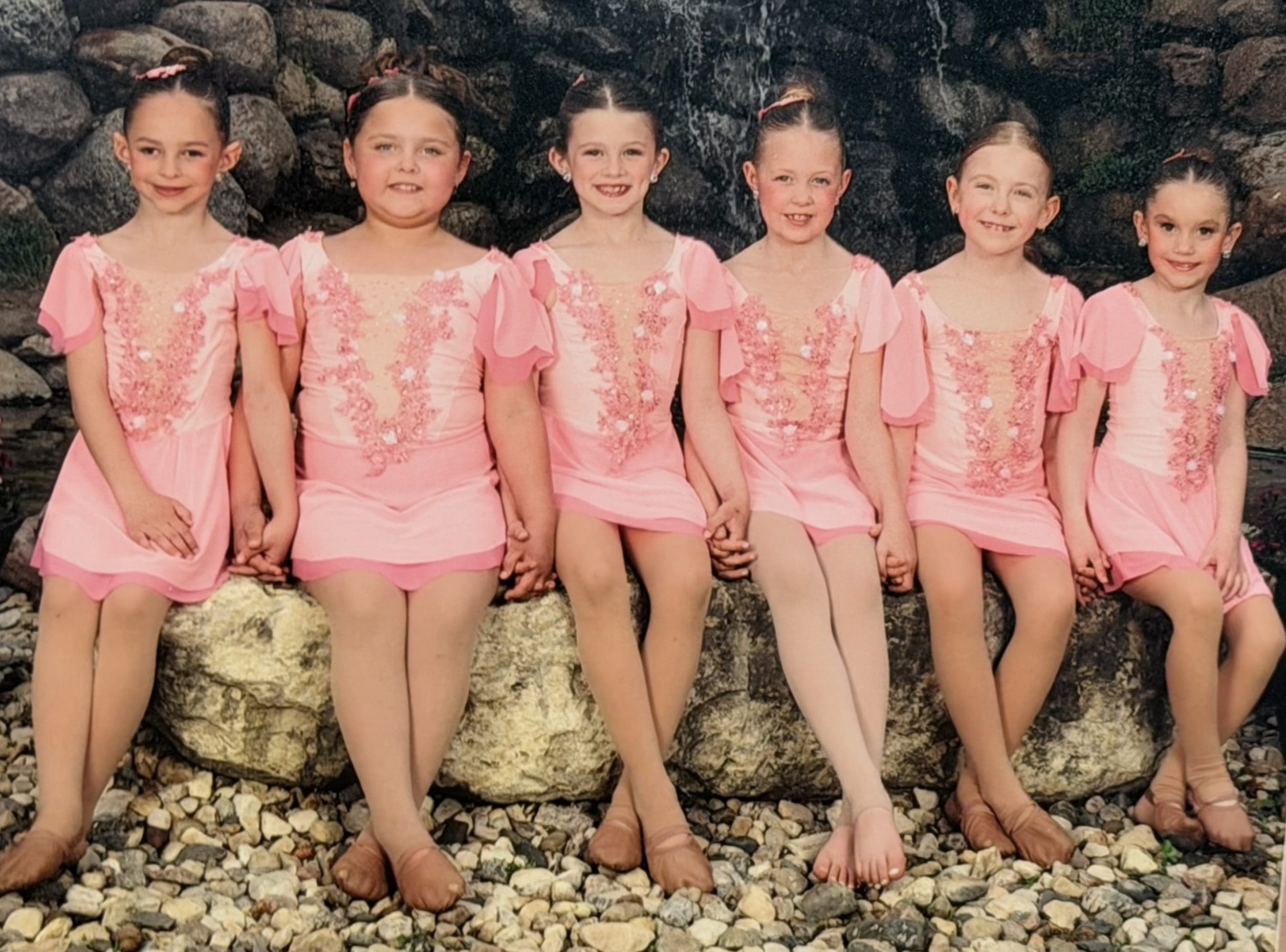 Custom designed lyrical costumes for the 5678! Dance Studio 2025-26 Tiny Team from McCook Lake, SD. These soft pink two toned lyrical costumes, have tulip style sleeves, embellished with hand dyed lace for that perfect shade of pink, 3-D sequined flowers, hand rhinestoned and beaded embellishments. These costumes were designed and created by Sewn 2 Dance.