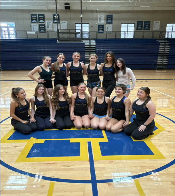 SOLO CUSTOM competetitve dancewear COSTUME CREATED BY SEWN 2 custom-fit dance costumes DANCE BLACK VELVET ONE SLEEVE WITH RUFFLE AND LARGE ROSE ON FRON Briar Cliff University in dance team in their custom game day costumes made by sewn 2 dance2025 performing on football field Our Story Sewn 2 Dance custom designs including Alterations and Embellishments behind the brand custom dancewear step 5 embellishments and rhinestoning, all the hand finishing touchs that make the costume our services team branding for HEELAN HIGH SCHOOL Custom pom and cheer uniform design for school teams CITY IOWA DANCE TEAM IN SCHOOL COSTUME SHIRTS EMBELLISHED BY SEWN 2 DANCE