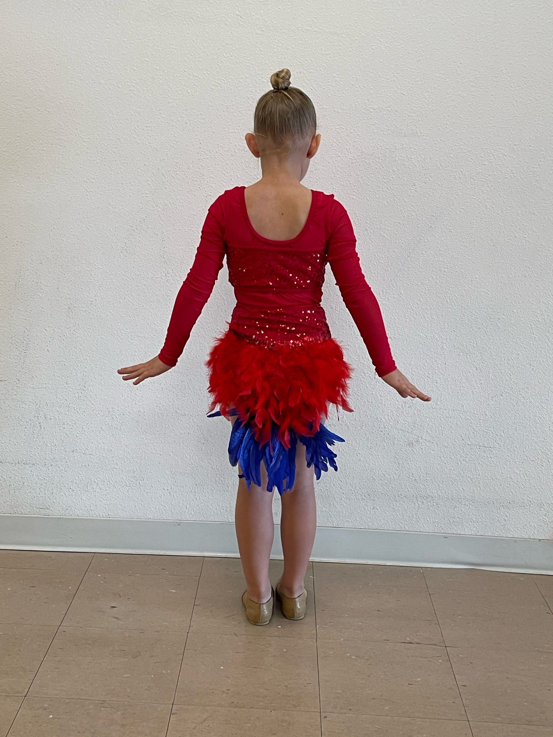 alteration and embellishments of girl in red dance costume added feather embellishments