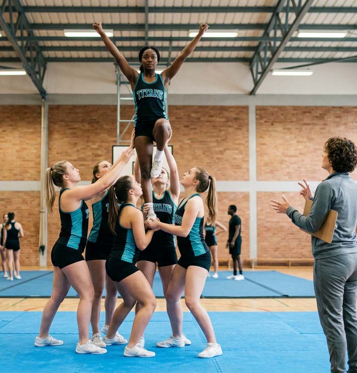 cheer organization practicing in and coach watching